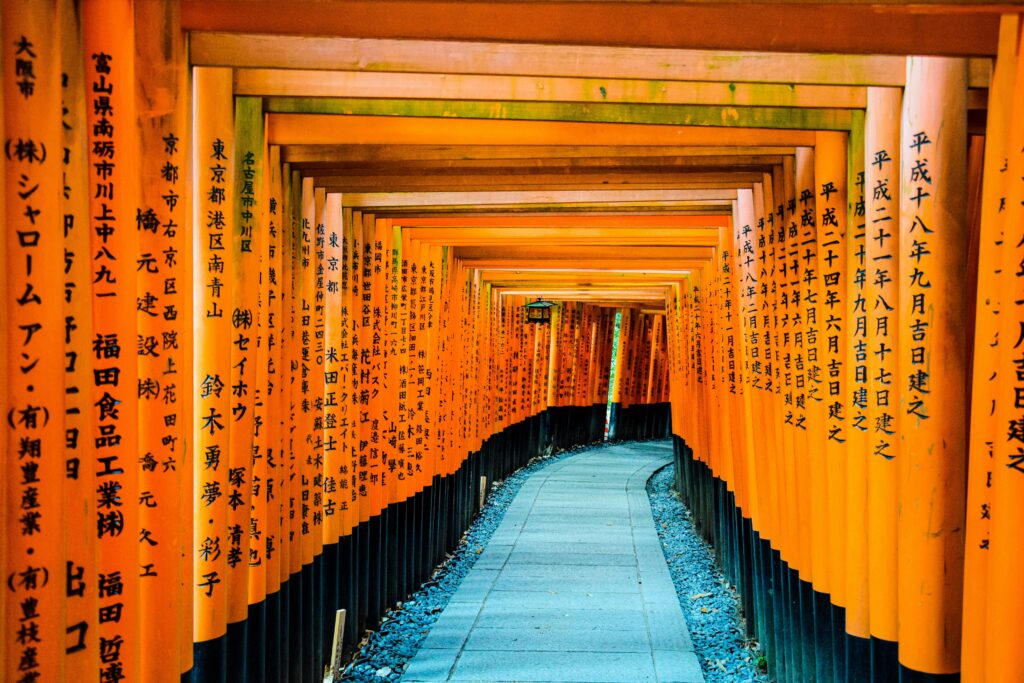 A striking view of the iconic orange torii gates at Fushimi Inari Shrine in Kyoto, Japan.